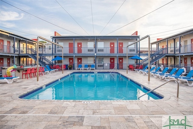 pool with fence and a patio