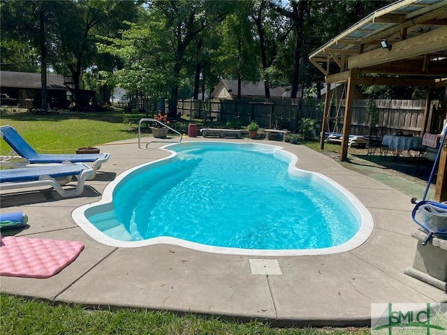 view of pool with a yard and a patio area