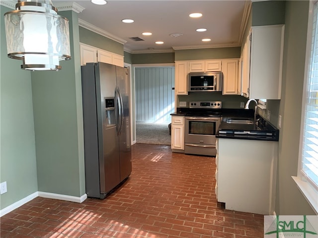 kitchen featuring ornamental molding, white cabinetry, sink, and stainless steel appliances