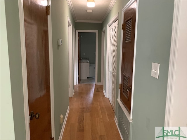 hallway featuring light hardwood / wood-style floors and crown molding