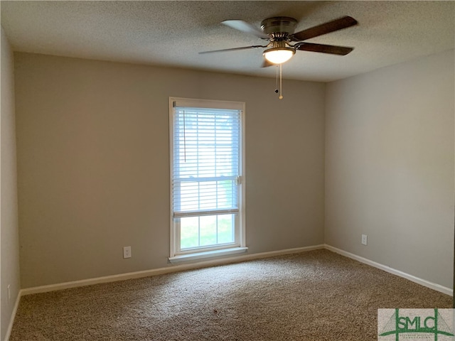 carpeted spare room featuring ceiling fan, a wealth of natural light, and a textured ceiling