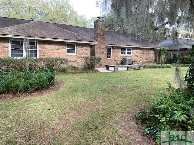 rear view of property with a yard