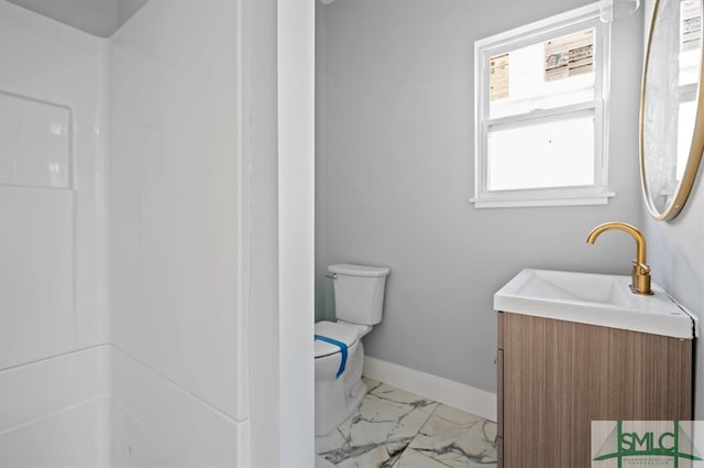 bathroom featuring toilet, tile floors, and vanity