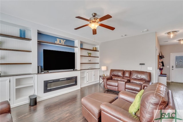 living room with built in features, dark hardwood / wood-style floors, and ceiling fan