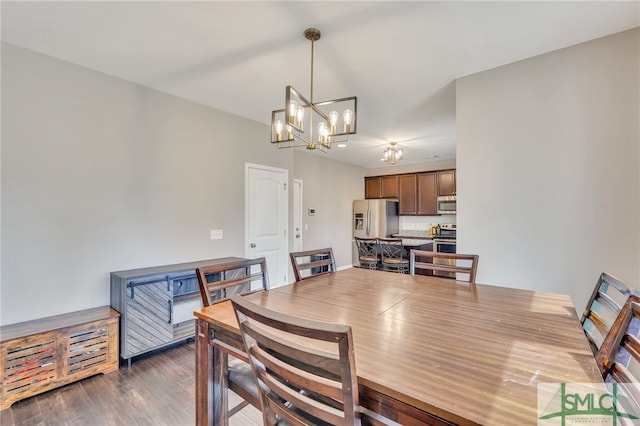 dining room with an inviting chandelier and dark wood-type flooring