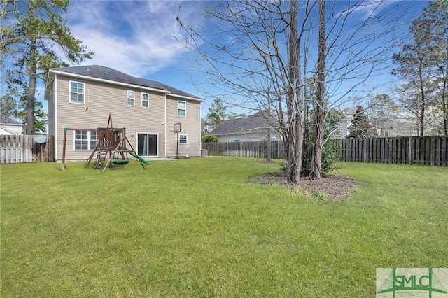 back of house with a playground and a yard