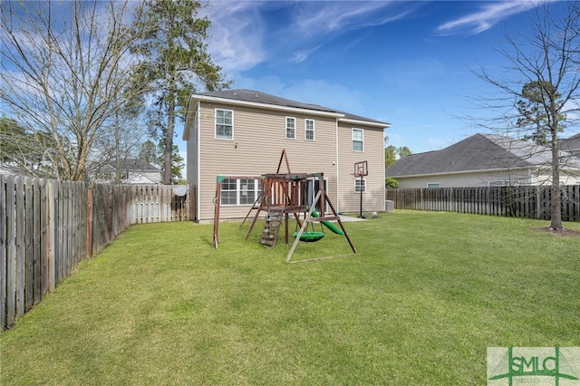 rear view of property with a lawn and a playground