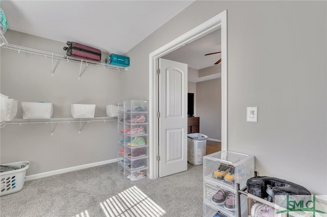 interior space with ceiling fan and light colored carpet