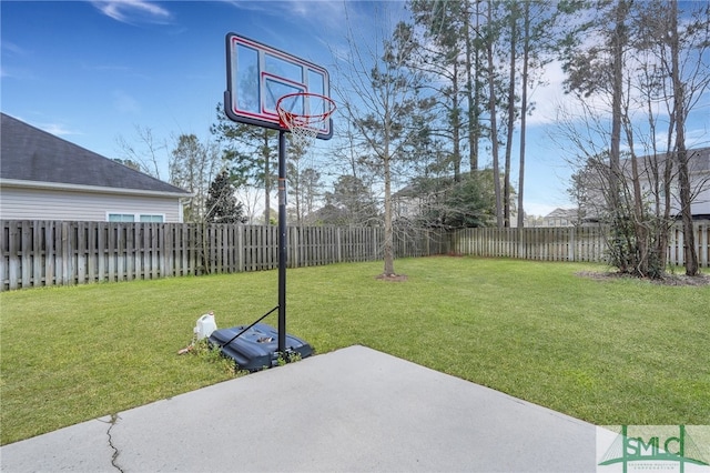 view of sport court with a yard