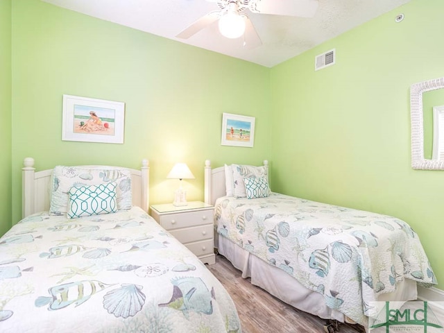bedroom with ceiling fan and light hardwood / wood-style flooring