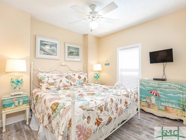 bedroom with ceiling fan and light hardwood / wood-style flooring