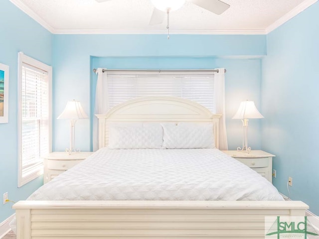 bedroom with multiple windows, ornamental molding, and ceiling fan