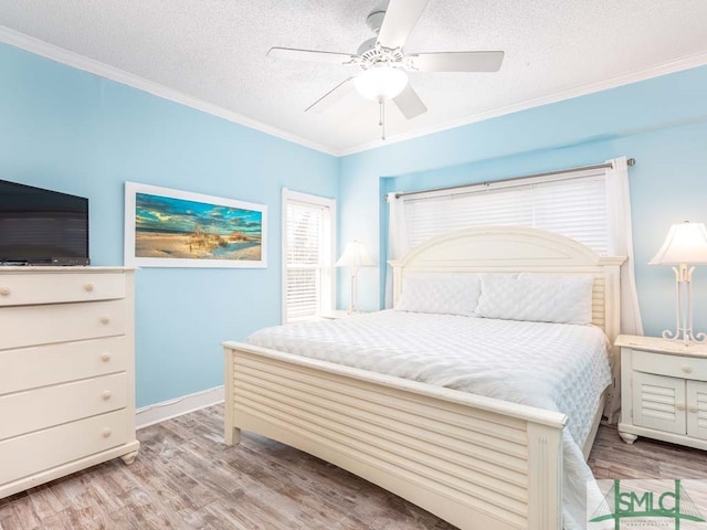 bedroom with ornamental molding, a textured ceiling, ceiling fan, and light hardwood / wood-style flooring