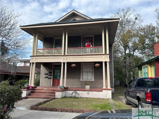 view of front of property featuring a porch and a balcony