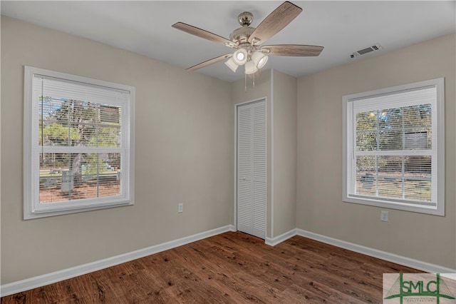 unfurnished room featuring ceiling fan and dark hardwood / wood-style flooring