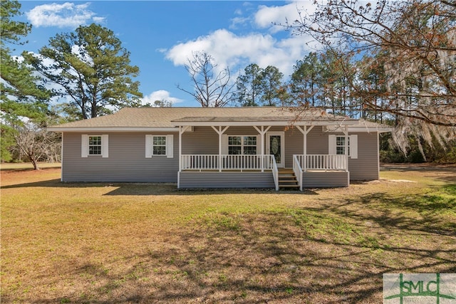 rear view of house featuring a yard