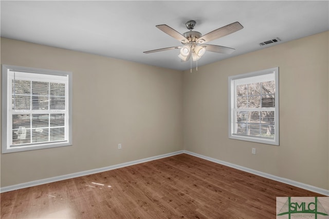 spare room featuring dark hardwood / wood-style floors and ceiling fan