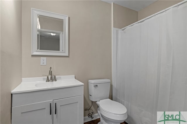 bathroom featuring toilet and vanity with extensive cabinet space