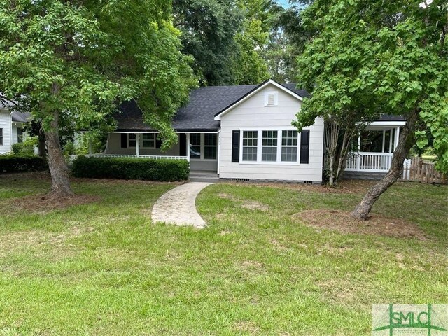 rear view of house featuring a lawn