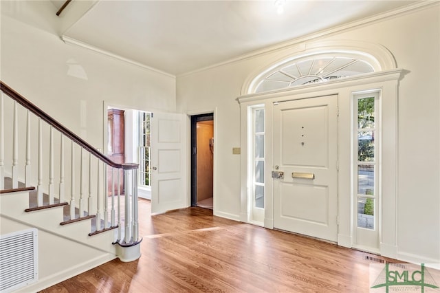 entrance foyer with light wood-type flooring and ornamental molding