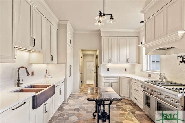 kitchen with tasteful backsplash, sink, double oven range, hanging light fixtures, and white cabinetry