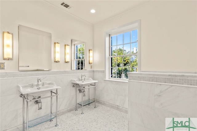 bathroom featuring sink, tile walls, and ornamental molding