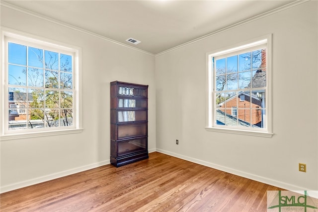 interior space featuring wood-type flooring and ornamental molding