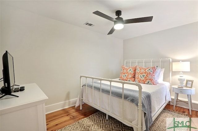 bedroom with ceiling fan and hardwood / wood-style floors