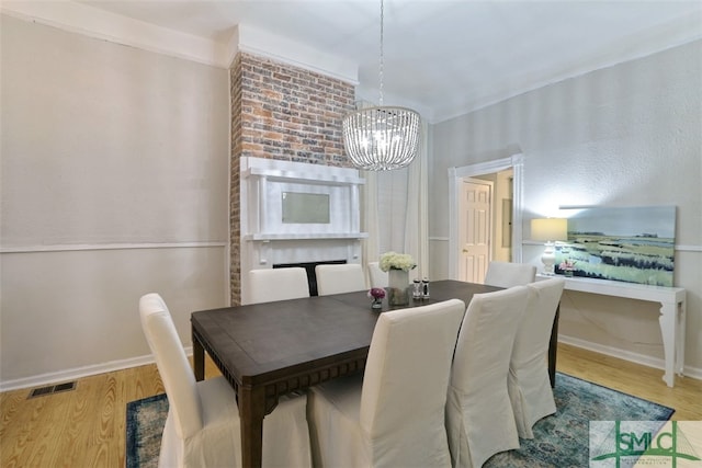 dining room with a chandelier and light wood-type flooring