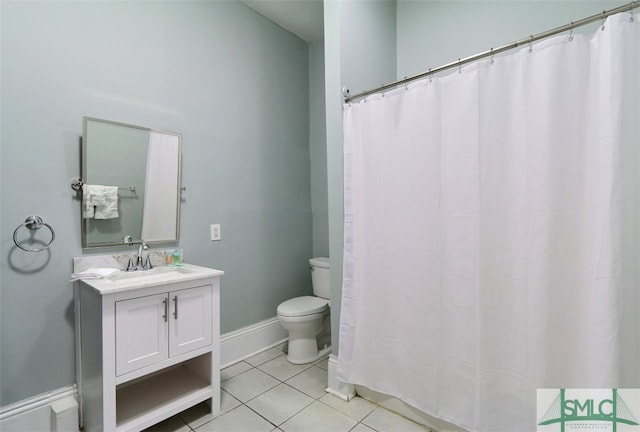 bathroom featuring tile floors, toilet, and large vanity