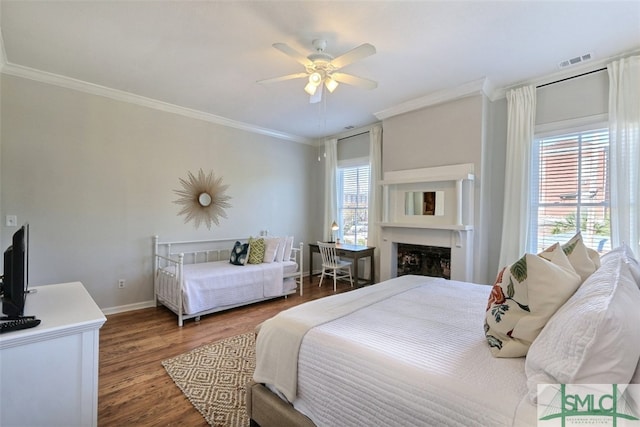 bedroom with ceiling fan, ornamental molding, and hardwood / wood-style floors