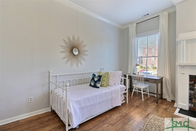 bedroom with crown molding and dark hardwood / wood-style floors