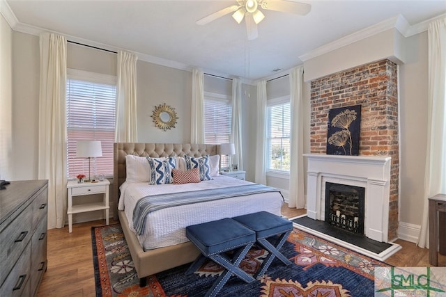 bedroom featuring ceiling fan, ornamental molding, and hardwood / wood-style flooring