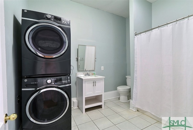 washroom featuring sink, stacked washer / drying machine, and light tile floors