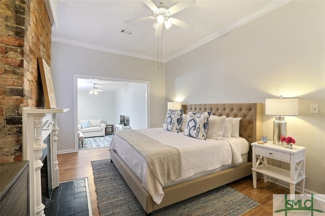 bedroom with ornamental molding, ceiling fan, and dark hardwood / wood-style flooring