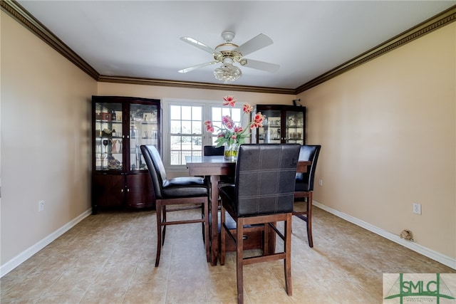 tiled dining area featuring ceiling fan and ornamental molding