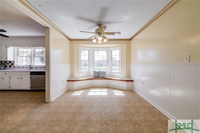 tiled spare room with crown molding, a healthy amount of sunlight, and ceiling fan