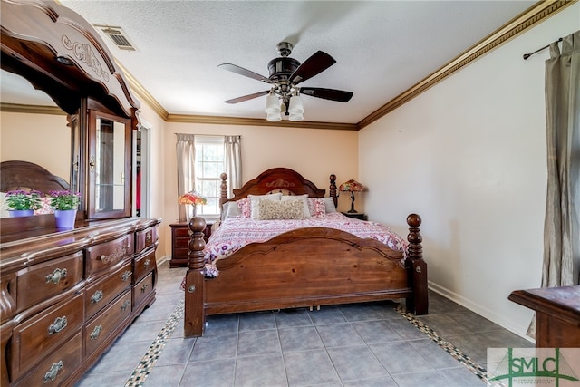 tiled bedroom with ornamental molding, ceiling fan, and a textured ceiling