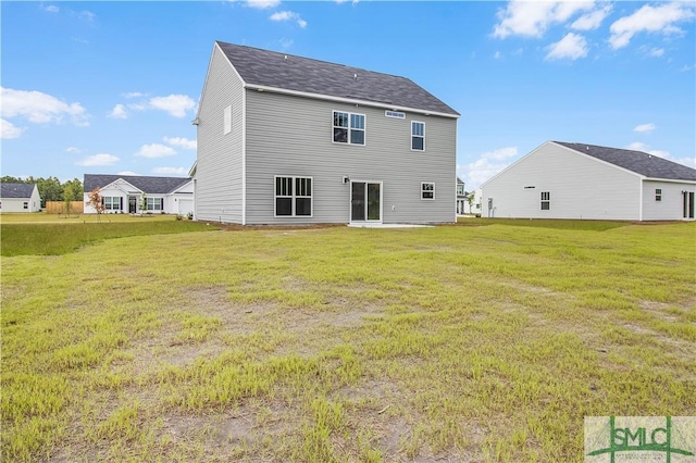 rear view of house featuring a lawn