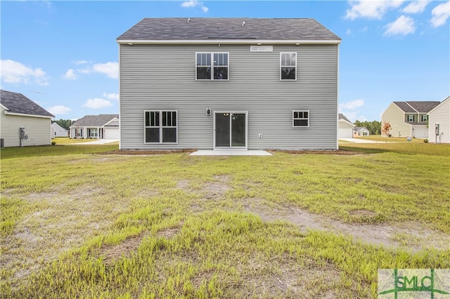 back of house featuring a patio and a yard