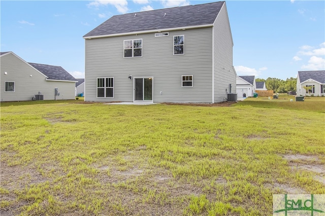 back of property with a yard and central AC unit