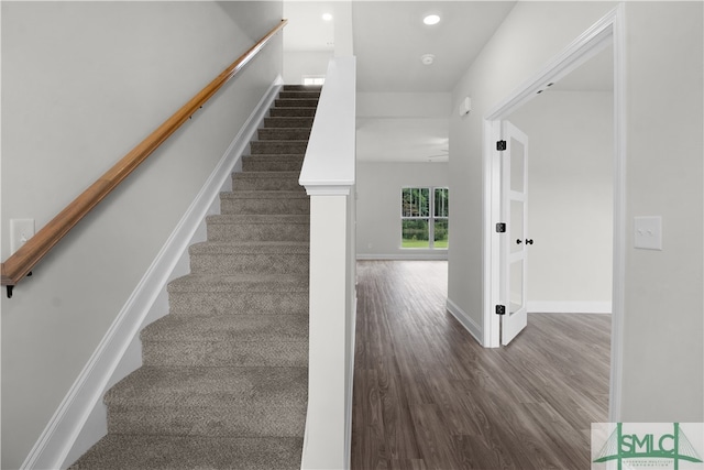 stairs featuring wood-type flooring