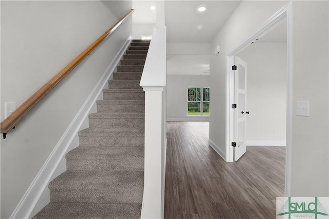 stairs featuring recessed lighting, wood finished floors, and baseboards