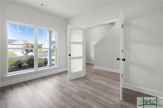 interior space with wood-type flooring and french doors