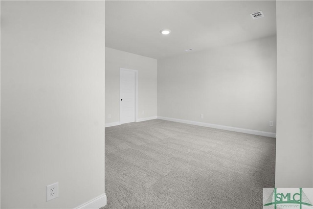 empty room featuring carpet floors, recessed lighting, visible vents, and baseboards