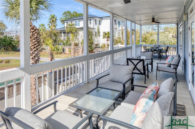 sunroom featuring ceiling fan