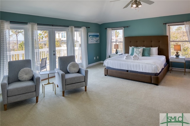 carpeted bedroom with multiple windows, access to outside, ceiling fan, and french doors