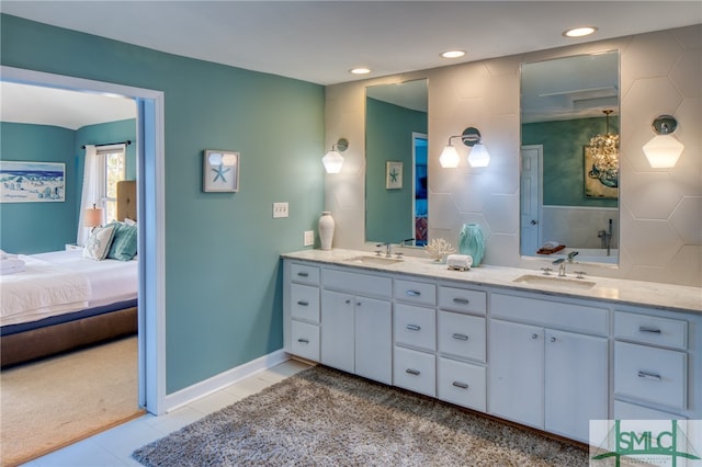 bathroom with double sink, large vanity, and tile floors