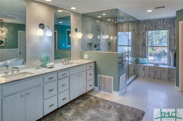 bathroom with independent shower and bath, tile floors, and oversized vanity