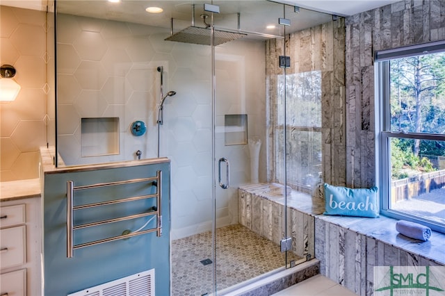 bathroom with a shower with door